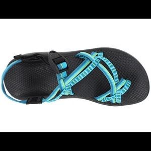 blue and green chacos with toe strap